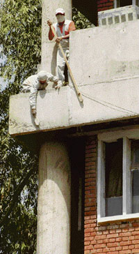 Labourers clean the facade of the UT secretariat in Chandigarh on Sunday.