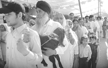 Devotees carrying sacrificial goats and liquor wait for their turn to pay obeisance to Kali Mata in Patiala on Sunday.