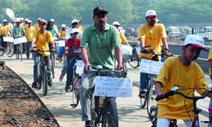 People participate in a cycle rally to highlight the benefits of the first of its kind non-motorised vehicle track at BRT corridor in the Capital on Sunday.