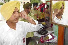 Sikhs take part in the turban-tying competition organised at Pohir near Ahmedgarh