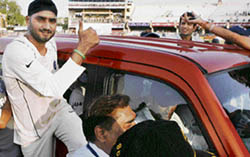 Harbhajan Singh hangs on to the Sumo Grande, received as Man of the Series award, while enjoying ride with the teammates after India defeated South Africa in the third and the last Test by eight wickets within three days in a pulsating contest at Kanpur on Sunday to level the three-match series 1-1