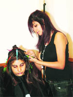 A model gets a hairdo during a workshop for beauticians in Amritsar