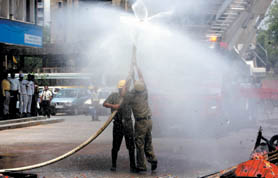 Firemen hold a mock drill at Barakhamba Road in the Capital on Tuesday.