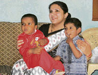 Deputy commissioner Deepti Umashankar plays with Ashwani (left) at an orphanage in Kaimri village near Hisar on Tuesday.