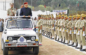 Chief Minister P.K. Dhumal inspects the parade at the state-level Himachal Day function at Kanjayan, near Bilaspur, on Tuesday.