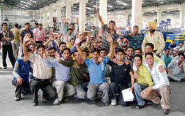 Workers of Euro Solo, an industrial unit at Baddi, hold protest in front of the factory gate on Tuesday.