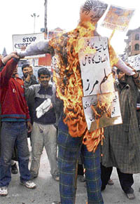 Activists of Peoples Freedom League burn an effigy of the Tihar jail superintendent during a demonstration in Srinagar on Tuesday.