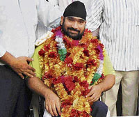 Rajinder Singh Rahelu at Ludhiana railway station on Tuesday before his departure for New Delhi to take part in the Olympics torch relay.
