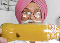 Seetal Singh shows a bottle of Maaza containing a big insect in Ludhiana on Tuesday.