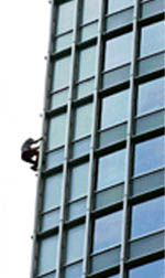French Spiderman Alain Robert climbs up the Four Seasons Place service apartment adjacent to the Four Seasons Hotel in Hong Kong