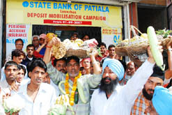 People stage protest against the spiralling prices of food items that have gone beyond the reach of the common man, in Bathinda