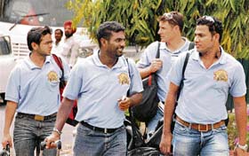 Sri Lanka spinner Muttiah Muralitharan (second from left) arrives with his teammates at a hotel in Chandigarh