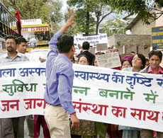 People protest against the non-availability of staff and facilities at the zonal hospital in Dharamsala on Wednesday.