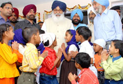 Children from poor families seek CM Parkash Singh Badals blessings at Badal village in Muktsar