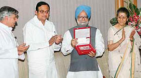 Prime Minister Manmohan Singh releases a coin to commemorate the 150th anniversary of the First War of Independence and other related events of the freedom struggle, while union minister of finance P. Chidambaram, union tourism minister Ambika Soni and minister of state for finance Pawan Kumar Bansal look on at a function in New Delhi on Friday.
