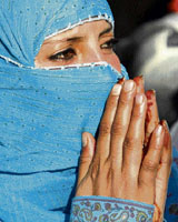 A Kashmiri woman prays upon seeing the relic of Sheikh Abdul Jeelani, a Sufi saint, on his death anniversary at a shrine in Srinagar on Friday.