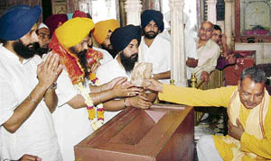 Youth Akali Dal president Kirandip Singh Kang pays obeisance at the Durgiana Temple in Amritsar on Friday.
