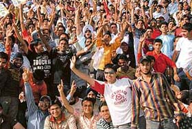 Spectators cheer during a Twenty20 match between Kings XI Punjab and Chennai Super Kings at the PCA Stadium in Mohali