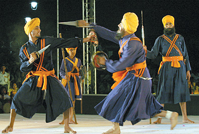 Sikh youths perform Gatka at the closing ceremony of the Olympic Torch Relay held at Central Prak in Connaught Place in the Capital. The two-day function was organised by the Delhi government.