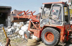 A demolition squad of the mandi board removes encroachments from grain market at Salem Tabri, Ludhiana