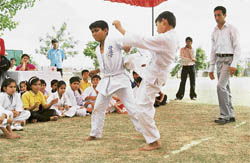 Karatekas in action during the Open Punjab State Karate Championship being played at Saraswati Modern School in Ludhiana