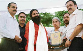 Baba Ramdev being honoured during a yoga camp in Amritsar on Saturday. Also seen in the picture is health minister Laxmi Kanta Chawla .