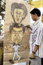 Cartoonist Shyama Prasad Dey gives final touches to his cartoon of Kolkata Knight Riders captain Sourav Ganguly and owner Shah Rukh Khan in Kolkata on Saturday.