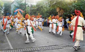 MUSICAL BONANZA: Folk dances by men and women are part of the vibrant procession