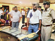 Policemen carry out investigation at a Tanishq showroom in Chandigarh where theft took place on Sunday.