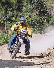One of the 35 participants in the Shimla motorcycle challenge (round 2) negotiates a curve on the 7-km-long track near Shoghi on Sunday. 