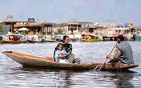 A Kashmiri woman and her child enjoy a boat ride at the Dal Lake