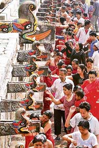 Nepalese Hindu devotees take a holy bath during the Balaju festival in Kathmandu