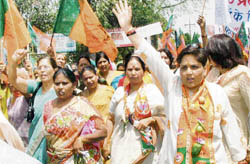 Members of the womens wing of the Bharatiya Janata Party stage a protest against rising prices in Sadar Bazar, Gurgaon