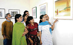 Students and art lovers at an exhibition of paintings by Bhup Gulia on the campus of Maharshi Dayanand University in Rohtak