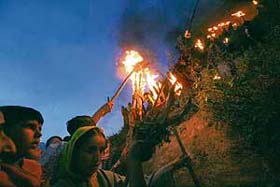Kashmiri Muslims hold torches on a hilltop outside the shrine of Sakhi Zain-ud-din Wali, a Sufi saint, during an annual torch festival in Aishmuqam, 75 km south of Srinagar