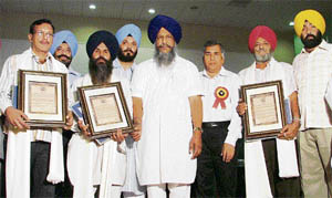 The honoured farmers with minister for animal husbandry Gulzar Singh Ranike during the second foundation day celebrations of GADVASU in Ludhiana on Monday.