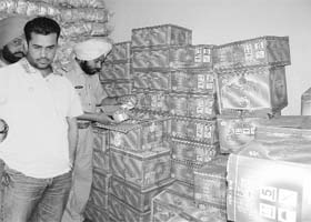 A police team raids the storehouse of a trader in the new grain market where it seized a huge cache of spurious ghee