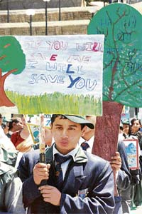 Students holding aloft placards participate in a rally organised by the HP State Pollution Control Board at Shimla to mark World Earth Day