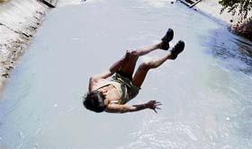 A boy jumps into the Ranbir canal to beat the heat in Jammu. On the whole, mercury is rising in the region