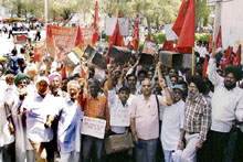 Industrial and farm labourers protest against inflation in Ludhiana on Tuesday.
