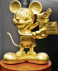A pure gold Mickey Mouse, weighing 1 kg, is displayed at a press preview for the promotion of Walt Disney's DVD "National Treasure 2" in Tokyo on Wednesday. The 12cm tall Mickey Mouse with a clapperboard, produced worth gold of $32,000, will be offered as a giveaway prize during the sales promotion of Walt Disney's DVD and Blu-ray disks.