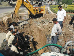 MCC workers carry out repairs on a freshly laid pipeline near the Grain Market rotary in Sector 26, Chandigarh, on Wednesday.