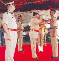 CISF director general R.K Das pins a fire services medal on head constable Babu Lal at a function in Ghaziabad on Wednesday.