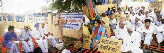 CPM state secretary Inderjit Singh addresses party activists during a protest against inflation in Fatehabad