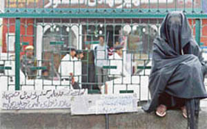 A CPM woman activist inside a park demonstrates against price hike in essential commodities in Srinagar on Wednesday.