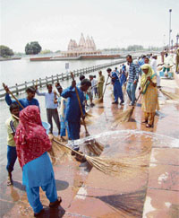 Kar sevaks clean a bank of the Brahm Sarovar in Kurukshetra on Thursday.