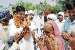 Kunal Bhadoo being greeted by villagers in Fatehabad during one of his recent visits. 