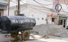 A water tanker of the horticulture wing of the MC parked outside the house of a sanitary inspector in Ludhiana on Thursday.