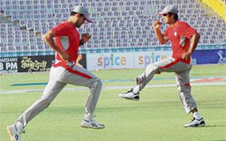 Irfan Pathan (left) and Kumara Sangakkara of Kings XI Punjab during a practise session in Mohali 