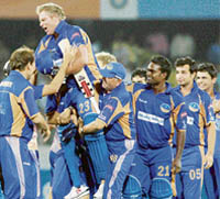 Rajasthan Royals skipper Shane Warne is lifted by teammates after he hit the winning stroke against Deccan Chargers at the Rajiv Gandhi International Cricket Stadium, Uppal, in Hyderabad
